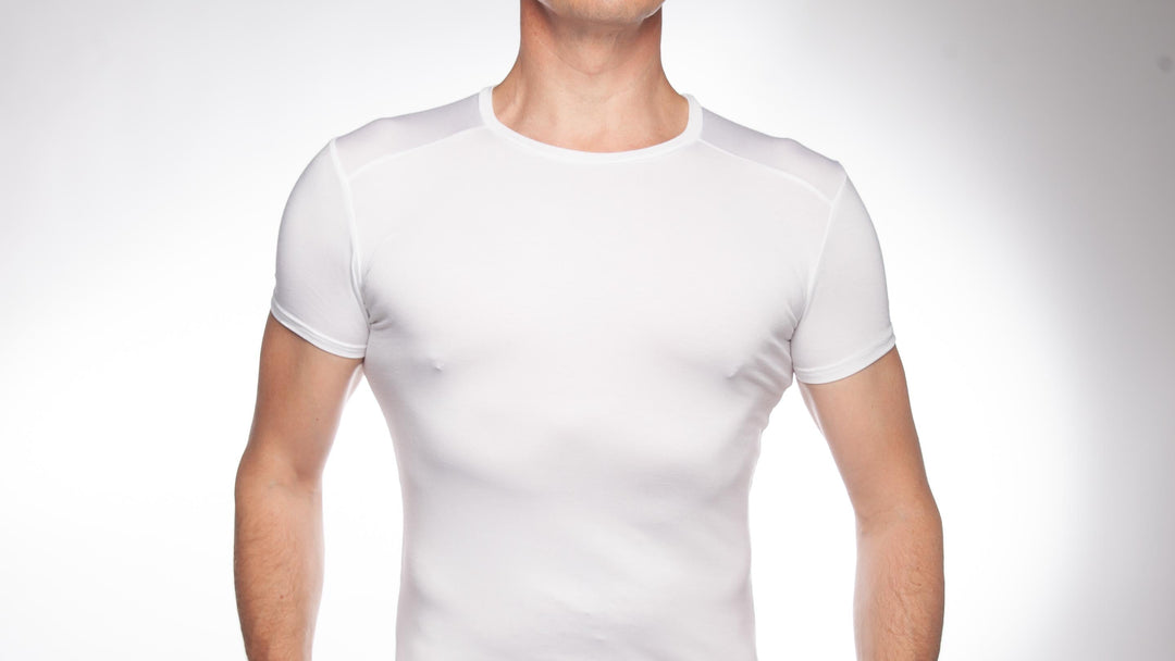 Man wearing white crew neck undershirt on a white backgound