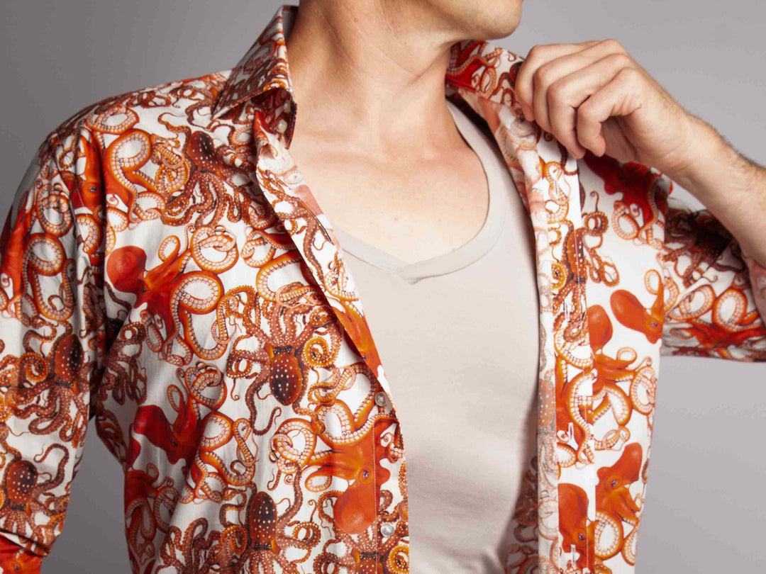 Picture of a man wearing an Oxford Sweat Protect undershirt in heather grey under an open shirt of orange octopus print