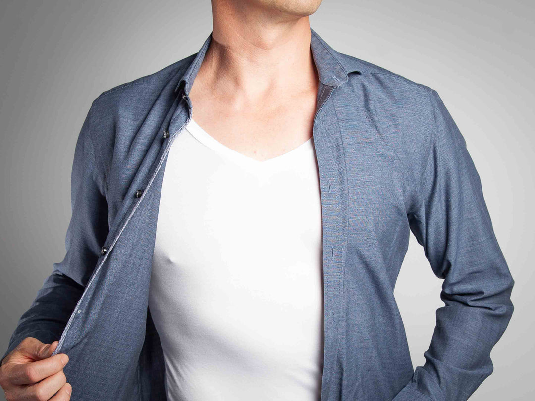 A white men's undershirt worn under a grey shirt which is open