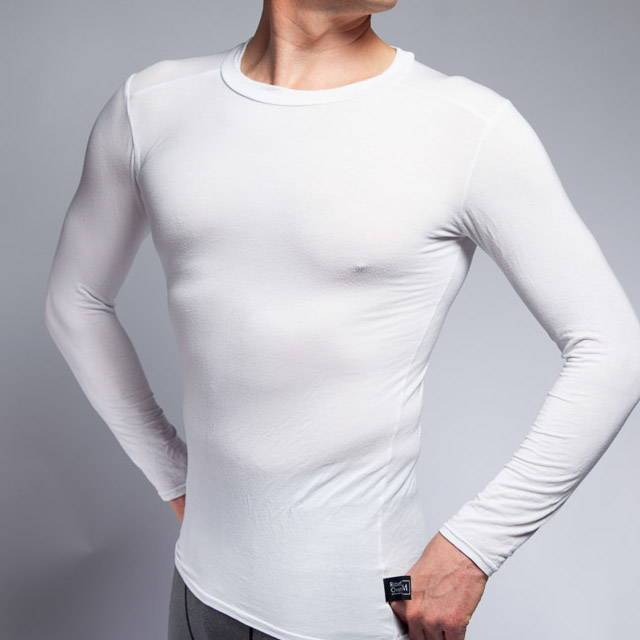 Man wearing a long sleeve undershirt in white. The undershirt is made from bamboo viscose.